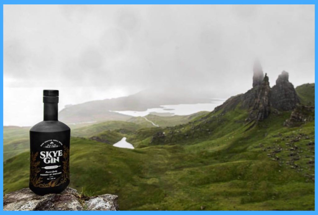 Black bottle of Skye Gin on a rock, over looking the Skye countryside
