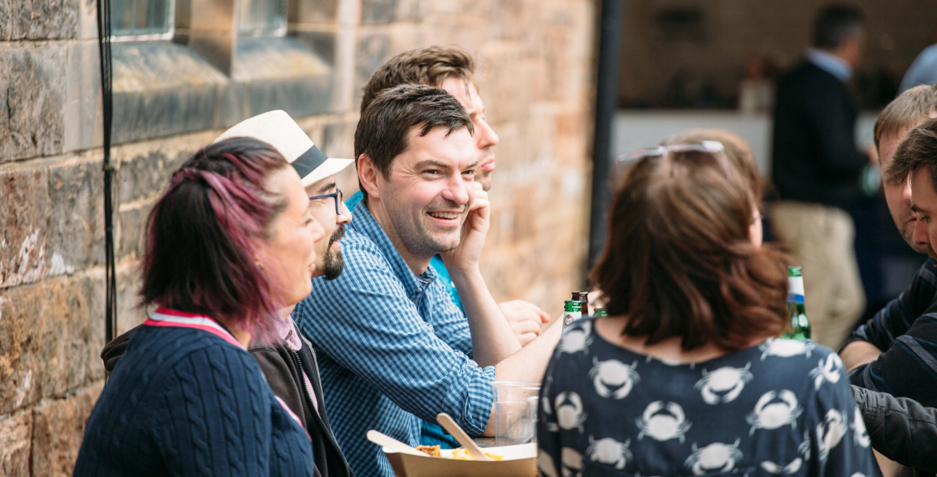 group of people sitting outside chatting